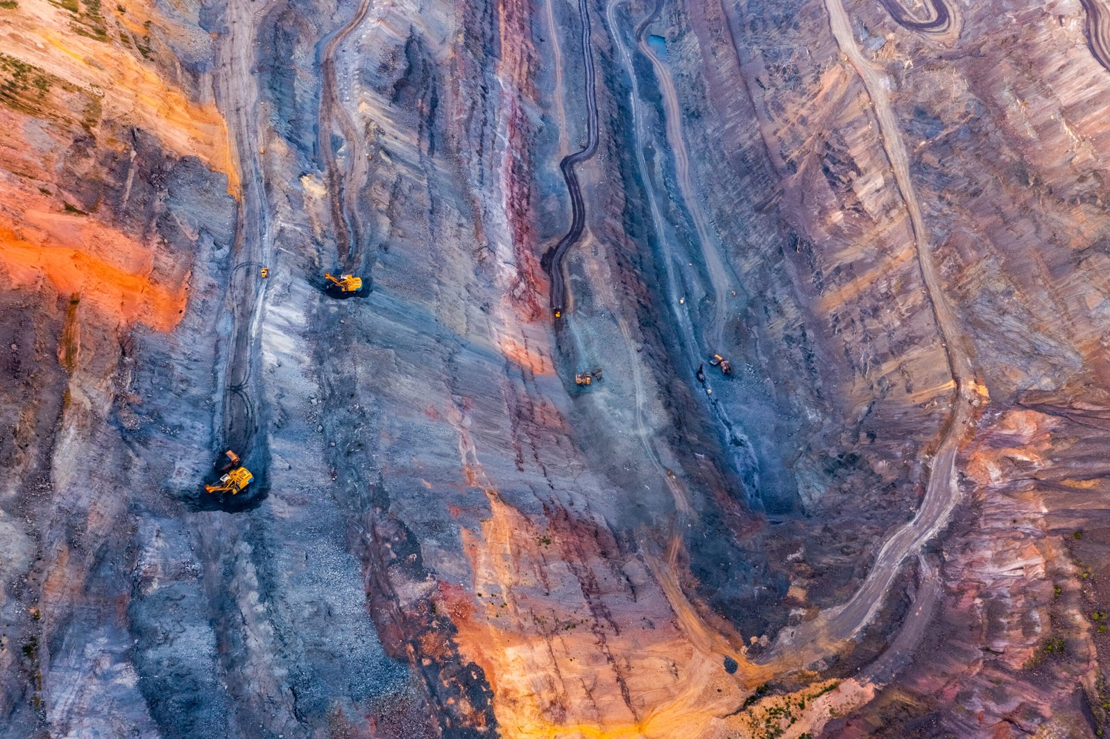 Large-scale open-pit mining operation with industrial excavation machinery used for metal extraction, ore recovery, and mineral processing.